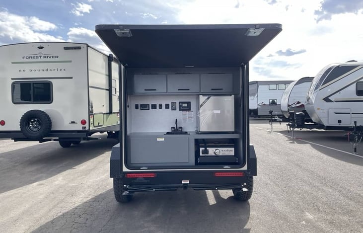 Kitchen is at the back of the trailer.  Includes:  Blackstone griddle, fridge and sink with an outside shower.