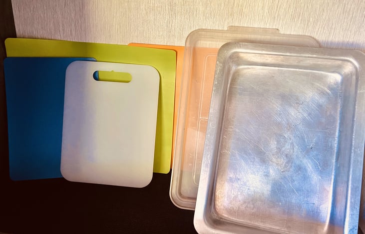 various cutting boards, and meat trays stored in the pantry.
