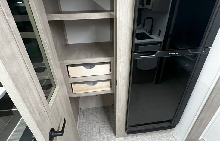 Pantry, 12 volt fridge, can be powered while traveling.