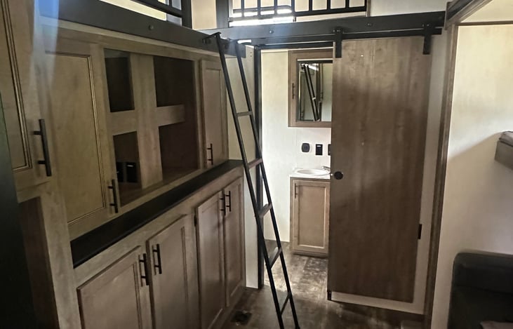 back bedroom featuring storage area and upper loft.