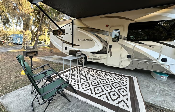 View of patio area includes rug and 2 zero gravity chairs