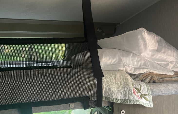 Above cab sleeping area - Queen sized space with memory foam topper for enhanced comfort. Sheets, blankets and pillows provided for all 3 beds.