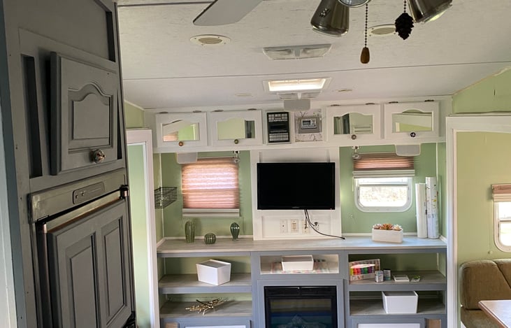 Charming and cozy Boho Chic living room with electric fireplace. Perfect for those cooler evenings.