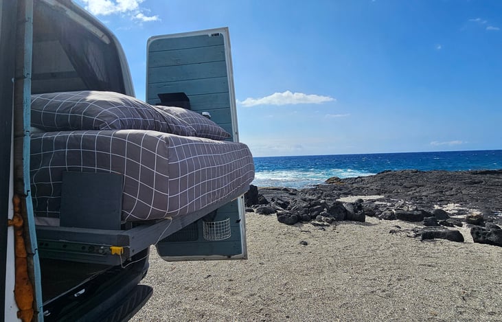 The bed slides out the back of the van on 500 LB ball bearing drawer slides so you can sleep under the stars.  You may even see Aliens.