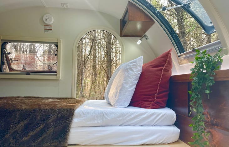 Happy comes with 2 twin mattresses (74"x35") that can be stacked on top of each other for one person, or side by side to make a queen sized bed. Pictured here stacked.