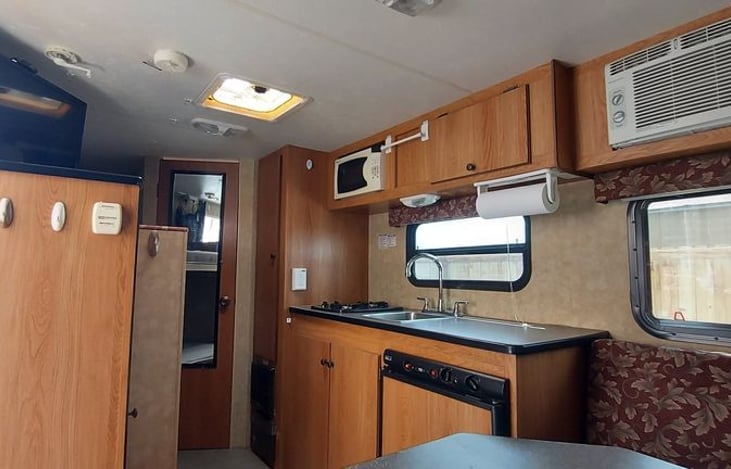 kitchen with microwave and A/C unit