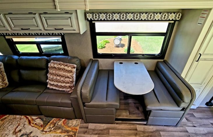 The middle table can fold down and cushions can turn into a bed