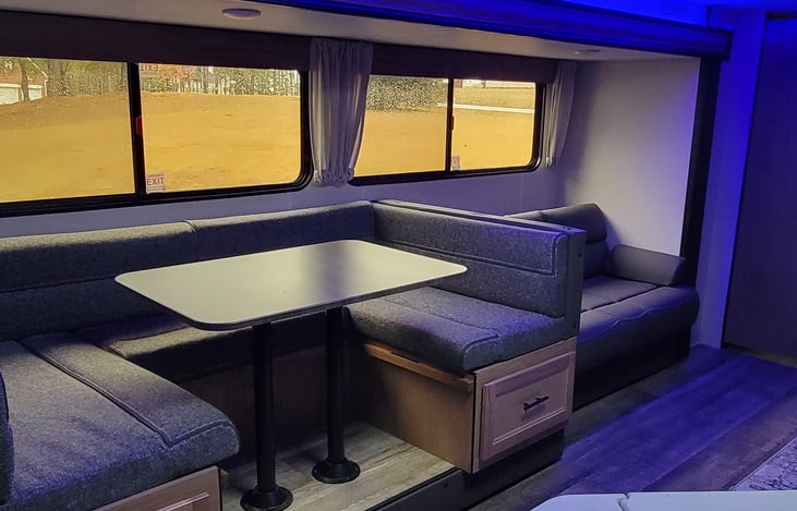 Cozy dinette and couch also can be converted into sleeping quarters