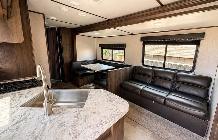 Open-concept living space with modern kitchen, dining area, and comfortable seating