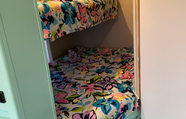 Kids bunk area. Top bed is single person (up to 200lbs) and bottom can fit two. Also have a railing if needed for the top bed.