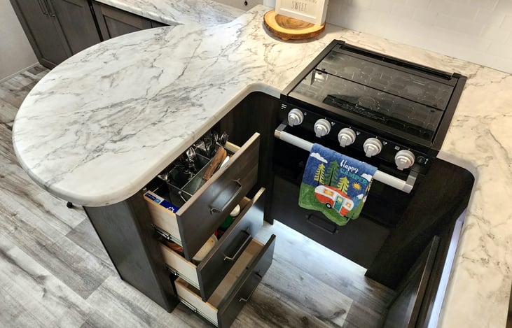 Silverware and misc items in the drawers of the peninsula.