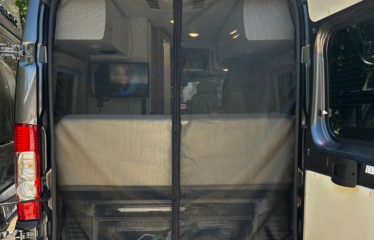 In the back you’ll find a magnetic bug net,
magnetic privacy shades for back windows, a 9x18 ft mat, water hose,  handheld vacuum, exterior hose to rinse things off, electrical connections, etc.