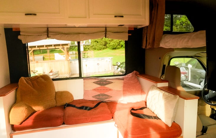 Couch with two seat belts, one backwards facing and one sideways. Drivers seat and passenger seat make 4 total seat belts.