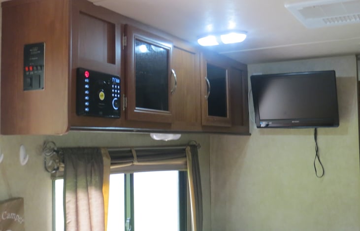 ‘Entertainment center’ TV with HDMI hookups, plenty of space in cabinets to hold games/movie etc. Radio/CD player with speakers in and out