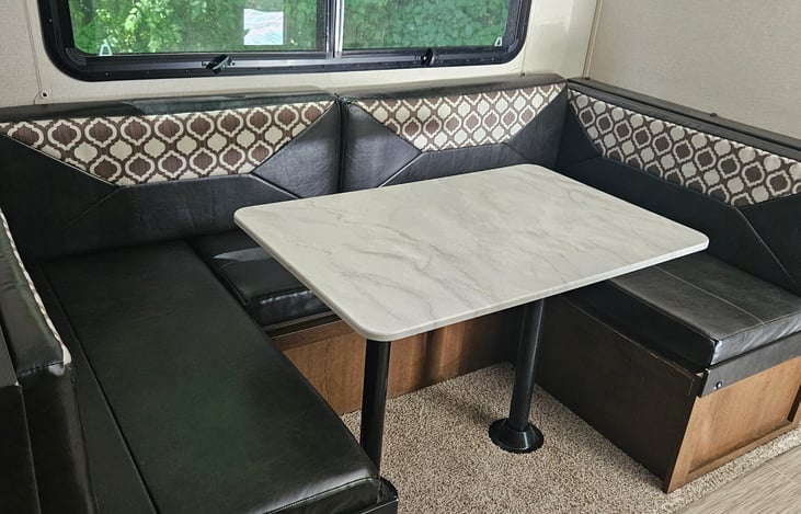 Large versatile dinette, can be used as dining table, couch (if you remove table) or double bed. Pack n play also fits nicely in this area.