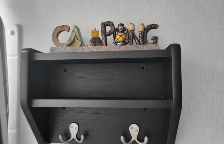 Bathroom shelf with hooks and camping night light.