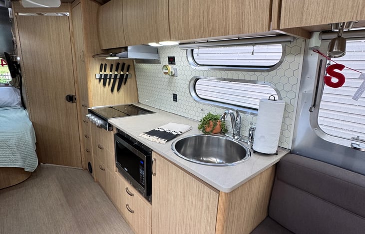 Kitchen is stocked with pots, pans, and utensils.