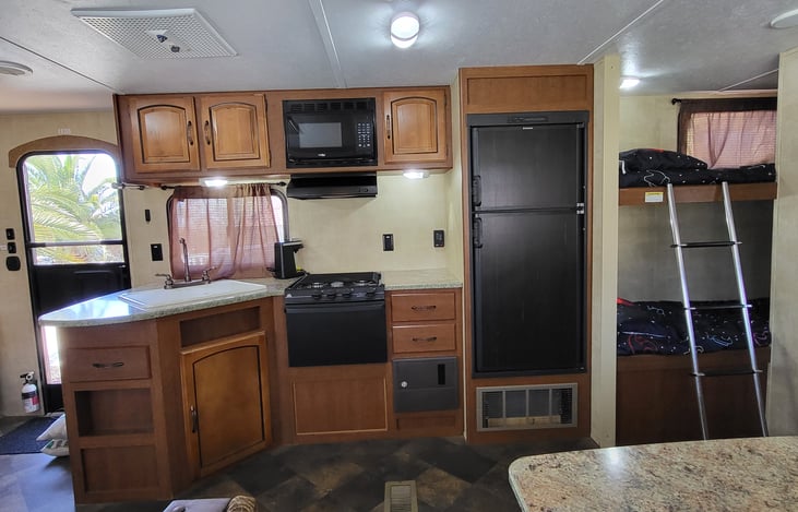 Full Kitchen. Spacious sink. Microwave. Refrigerator and freezer. Gas Stove and oven. Plenty of cabinet space. BunkHouse to the right of kitchen.