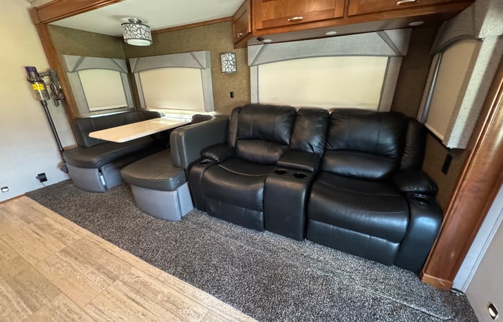 Two recliners with cup holders are comfortable enough to sleep in. Dining table with storage below.