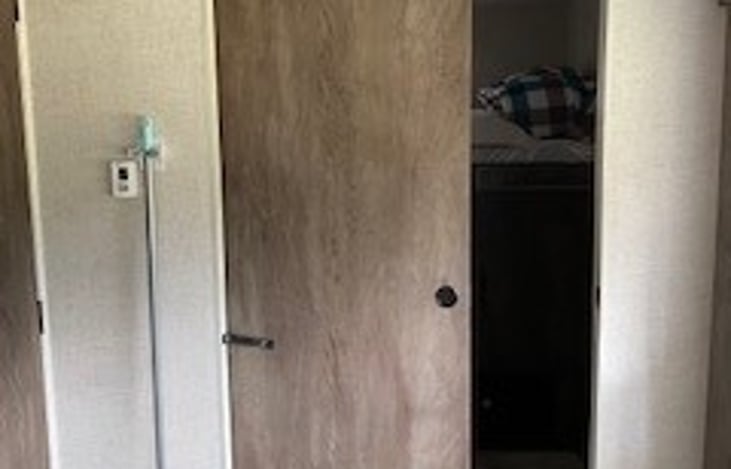 Showing that there is a slide door that separates the spare room from the kitchen/family room.