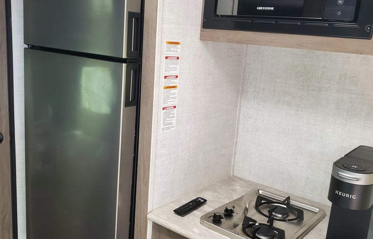 Kitchen has a nice size fridge