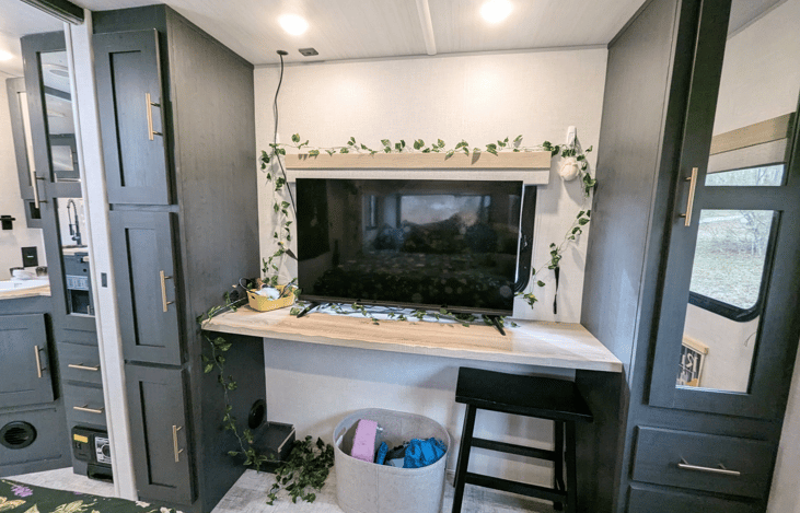 Large TV in spacious bedroom and built-in desk/dresser combo makes for a great place to work.