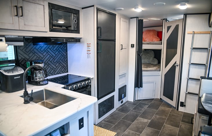 A fully-equipped kitchen ready for all your culinary adventures! Featuring a gas stove, microwave, refrigerator, freezer, and a spacious pantry—everything you need to make your favorite meals on the r