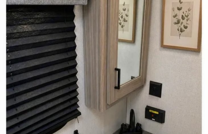 "Smoky Pass" features a private bathroom with a toilet, sink, and shower, giving you the convenience and privacy of a full bathroom wherever you travel—no campground bathhouses required.