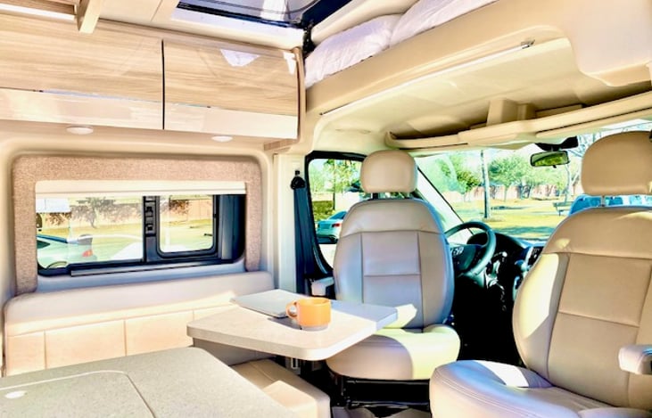 The van is equipped with a front (shown) and rear table that are both removeable for extra room in both lounge areas!