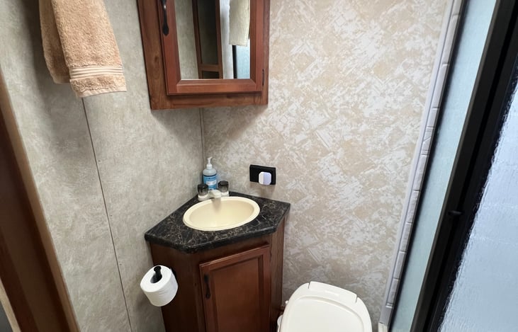 Freshly updated and thoughtfully maintained, the bathroom features, a shower, toilet, sink, a new flooring for a clean, comfortable experience.
Towels shown are for staging purposes only.