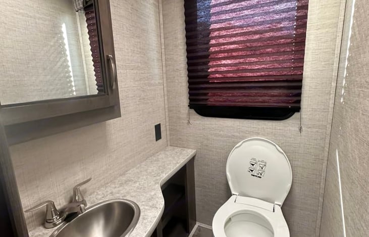 Split bath.  The toilet and sink are on the left, and the shower is on the right.  Privacy is provided by a pocket door and the bathroom door also opens up and can close the bedroom off.