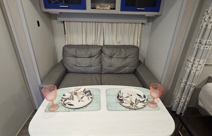 Comfy loveseat and pedestal table with added bench seating