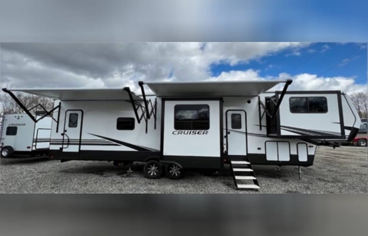 Front with 2 awnings and outdoor lighting