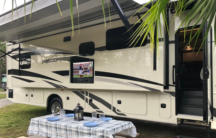 We include all you need for outdoor living with folding table, tablecloth, outside TV, rocking camping chairs, outside BBQ grill, and extra large awning.