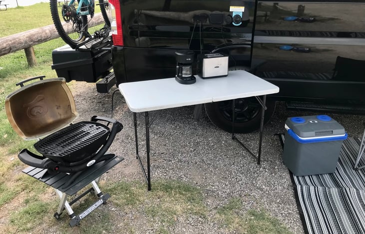 Grill hooked up to van’s propane quick connect, grill and coffee machine plugged in the power outlets on the side of the van as well as the 12V cooler