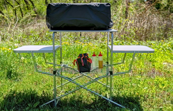 22" Blackstone on the grill table with Blackstone cover (that should be on when not in use) and a case of grilling utensils/tools. (Check out add-ons)