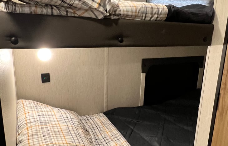 Comfy bunk beds with a light and USB ports for each.