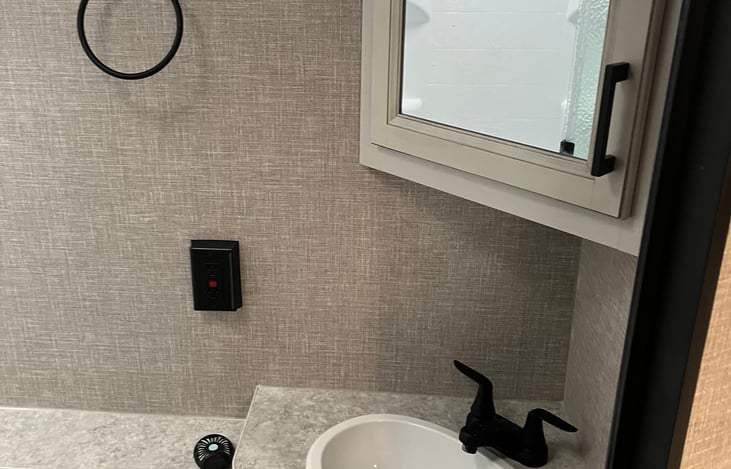 bathroom cabinet with sink and counter space, towel holder, and storage both above and below the sink—perfect for your organized toiletries and linens.