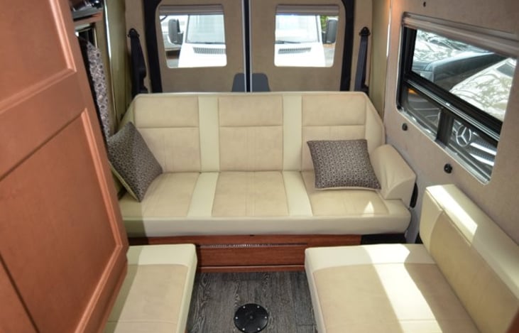 Comfortable sofa in the back with seatbelts