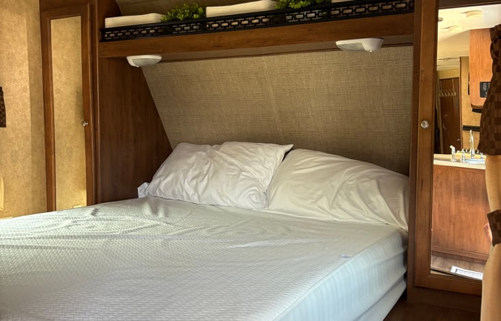 Bedroom with comfortable queen size bed, closets and pocket door for privacy.