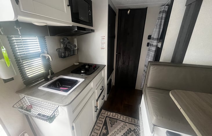 Slide out had dinning tablet, two bunks in back and full kitchen. Master bedroom is in front.