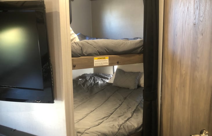 Double size bunk beds - linens included with rental.  curtain for privacy