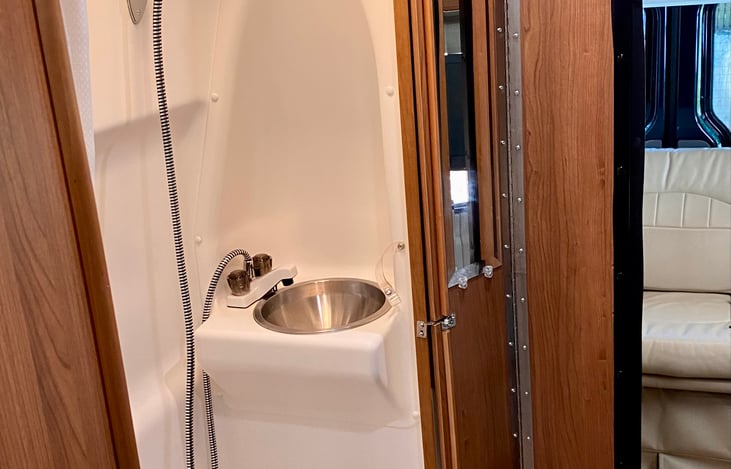 Bathroom with shower, toilet, sink, mirror