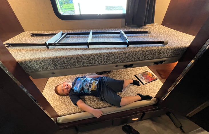 Bunks outside the bathroom! Can be folded up to have more space, for clothes or taller people!