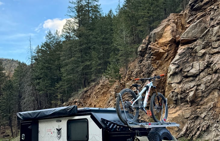 Custom dual bike rack featuring two 1UP-style trays that securely hold 27.5” and 29” carbon-fiber bikes with zero frame contact—ideal for high-end mountain or road bikes.