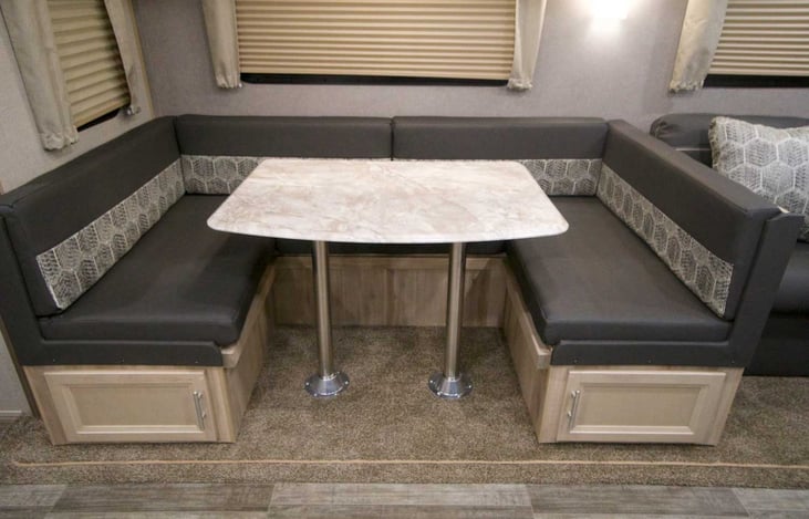 Cards,  home work or breakfast? Plenty of room at the U shaped dinette that also turns into a large cozy sleeping space,  we have provided foam topper mattress and sheets for this bed.