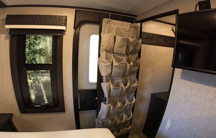 Shoe rack on the back of the closet door.