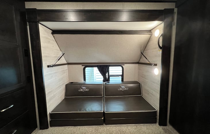 Top bunk can swing up for more space