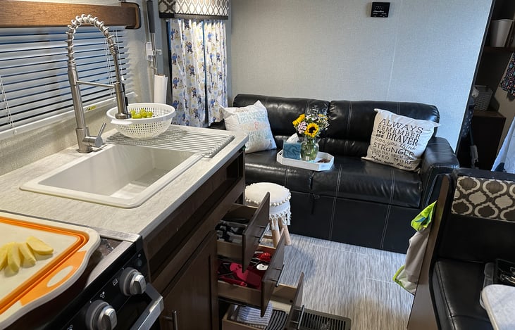 View from back of the trailer by bunk beds. Refrigerator, stove/oven & kitchenette to the left. Dinning and door to the right. Couch and entrance to master suit straight ahead. Isn’t it so cozy!?
