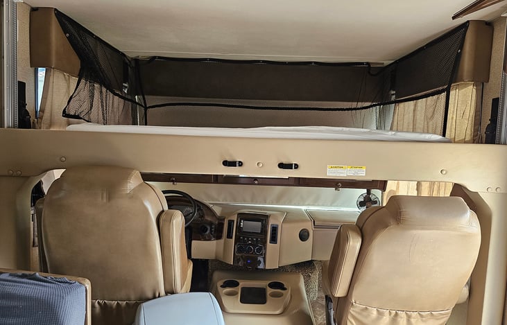 Bunk above captains chairs.